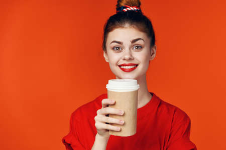 cheerful woman in red t-shirt with cup of coffee cropped viewの写真素材