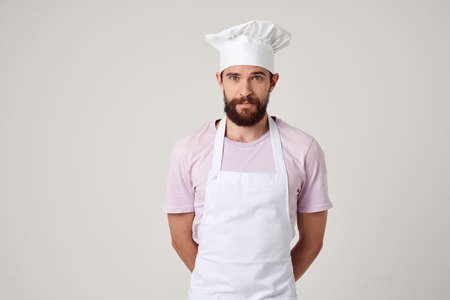 bearded man in white apron kitchen cooking restaurant