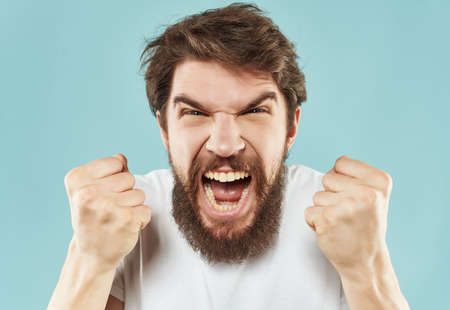 Man in a white t-shirt irritated facial expression close-upの写真素材