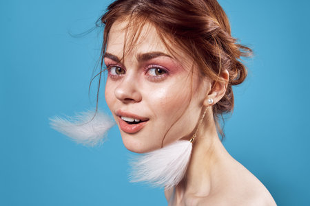 woman with bare shoulders bright makeup decoration fashion blue backgroundの写真素材