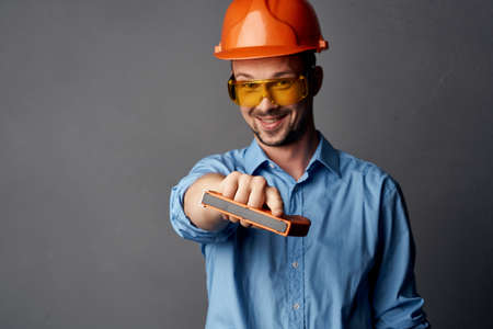 man in working uniform yellow glasses construction posing