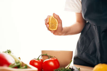 lemon in hand kitchen cutting vegetables salad cooking