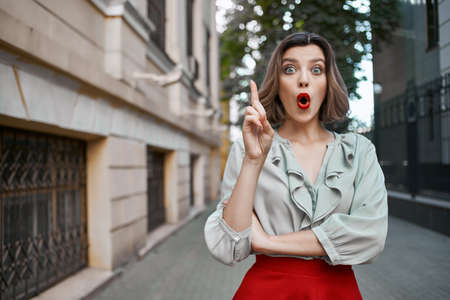 emotional woman outdoors walk posing near buildingの写真素材