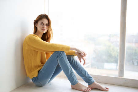 red-haired woman in a yellow sweater Lifestyleの写真素材