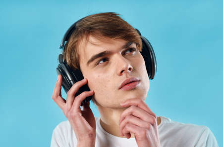 emotional guy in white t-shirt wearing headphones music fashionの写真素材