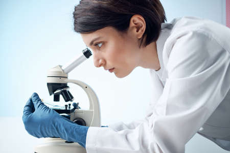 female laboratory assistant looking microscope diagnostics professional science