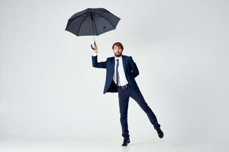 business man in suit umbrella protection self-confidence studioの写真素材