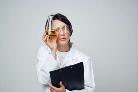 female doctor in a medical gown chemical solution laboratory