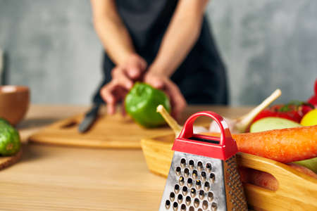 Woman in black apron Cooking healthy eating cutting boardの写真素材