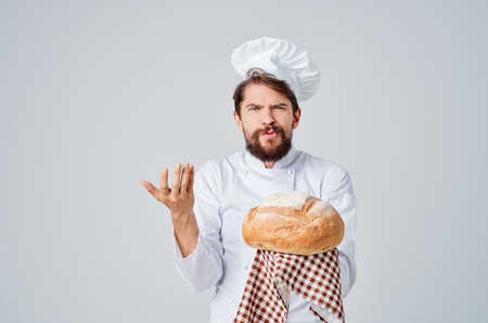 Baker with bread in hand Professional emotionsの写真素材