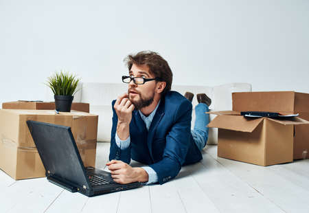 business man lying on the floor in front of laptop work office moving