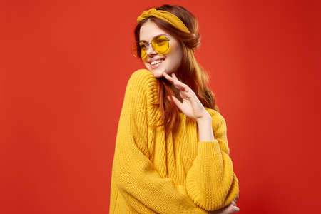 cheerful woman in yellow glasses sweater hipster fashion retro styleの写真素材
