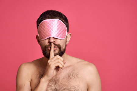 man with bare shoulders with towel on head skin care isolated backgroundの写真素材