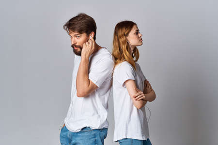 young couple white t-shirts next to lifestyle listening music friendship