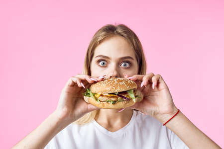 cheerful pretty woman in white t-shirt pizza fast food snack restaurantの写真素材