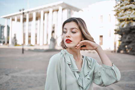 pretty woman outdoors in city near buildings lifestyle