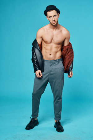 attractive man wearing hat fashionable clothes posing studio isolated backgroundの写真素材