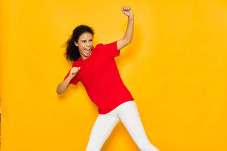 woman in red t-shirt emotions fun yellow background