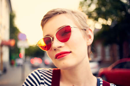 woman wearing sunglasses outdoors walk posing fashionの写真素材