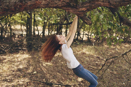pretty woman outdoors by the tree landscapeの写真素材