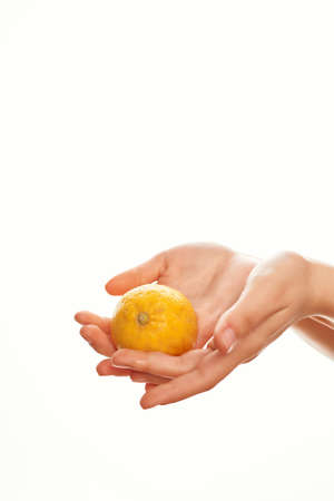 lemon in hand salad ingredient close-upの写真素材