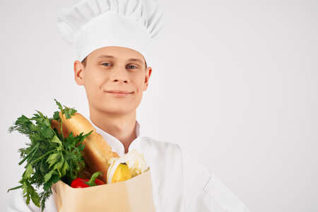 cheerful man chef food package kitchen cooking workの写真素材