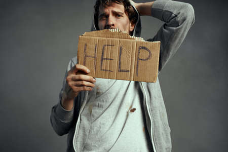 poor tramp holding a sign Help emotion loneliness on the streetの写真素材