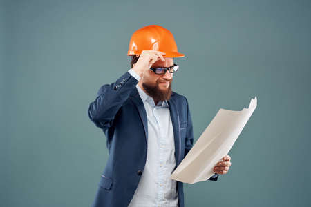 surprised man orange helmet on the head Studio hand gestureの写真素材