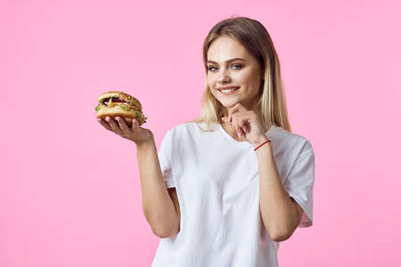 cute blonde in white t-shirt hamburger delicious food restaurantの写真素材