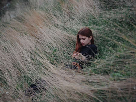 woman in a field in nature lies on the grass restの写真素材