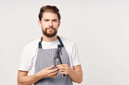 man in apron scissors comb provision of servicesの写真素材