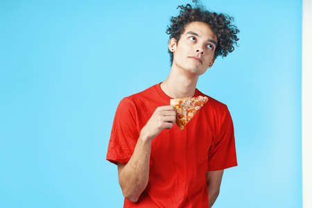 funny curly guy in a red t-shirt pizza delivery fast food snackの写真素材
