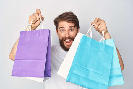 Cheerful bearded man with packages in hands shopping emotions close-upの写真素材