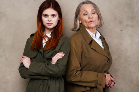 Mom and daughter in coat posing fashion autumn styleの写真素材