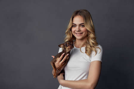 woman in white t-shirt with small purebred dog charm friendshipの写真素材