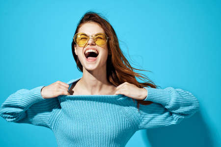 beautiful woman in a blue sweater isolated backgroundの写真素材