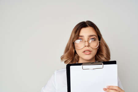 Business woman in glasses with a folder in hands documents close-up