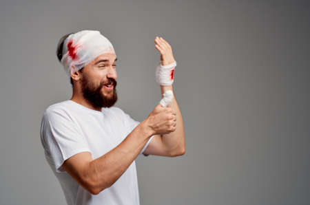 patient bandaged head and hand blood treatment