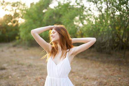 pretty cheerful woman in nature joy freedom sun