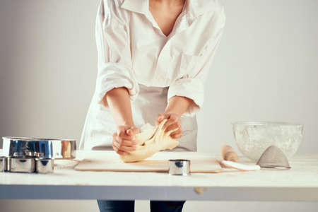 the chef rolls the dough cooking flour product in the kitchen