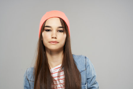 pretty fashionable woman modern style clothing posing gray background