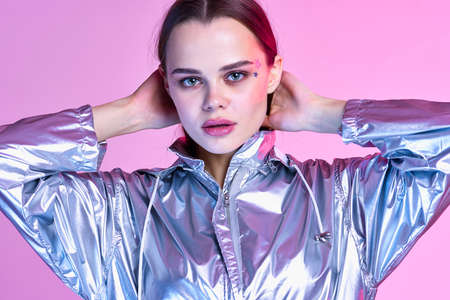 woman in silver jacket nightclub party posing isolated backgroundの写真素材