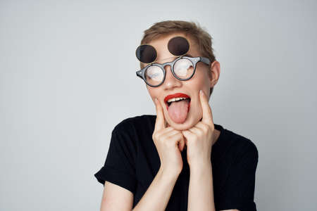 short haired woman hand gesture Red lips glamor light backgroundの写真素材