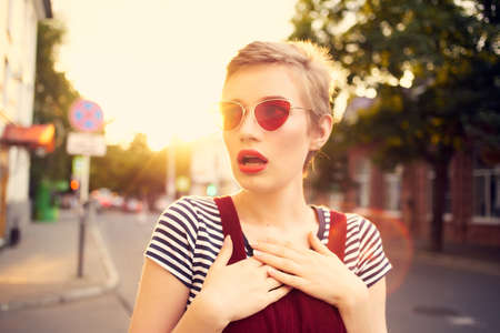 cheerful woman wearing sunglasses outdoors posing lifestyle