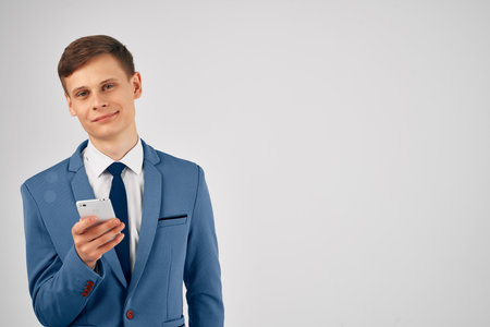 business man in a suit with a phone in his hands internet communication technologyの写真素材