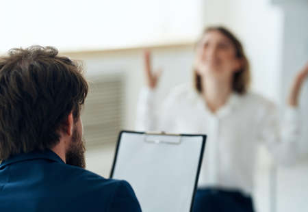 male psychologist next to woman patient therapy consultation treatmentの写真素材
