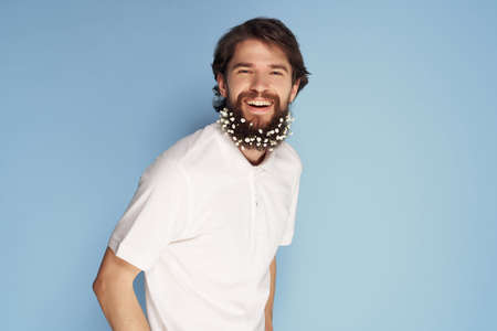 cute bearded man with flowers in hair emotions white shirt modern style natureの写真素材