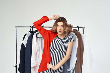 beautiful woman clothes hanger shopping light backgroundの写真素材