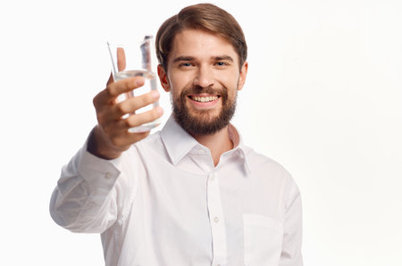 man in white shirt glass of water isolated backgroundの写真素材