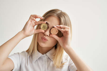 cheerful woman Bitcoin cryptocurrency in hands isolated backgroundの写真素材